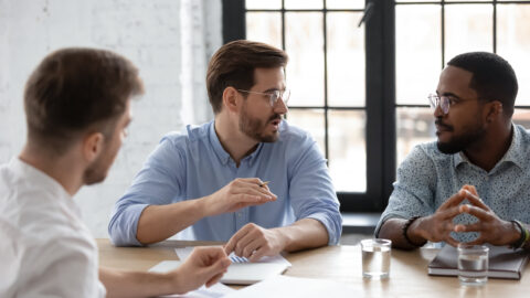 Diverse team discussing project strategy, sales and marketing reports
