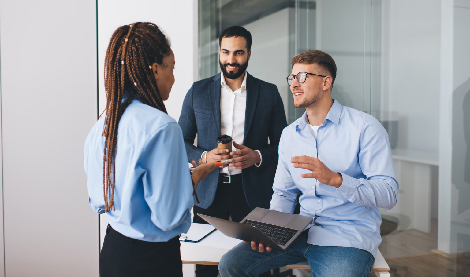 Diversity group of diverse marketing experts collaborating on business startup project discussing ideas in office interior, multicultural male and female employees with laptop computer communicate